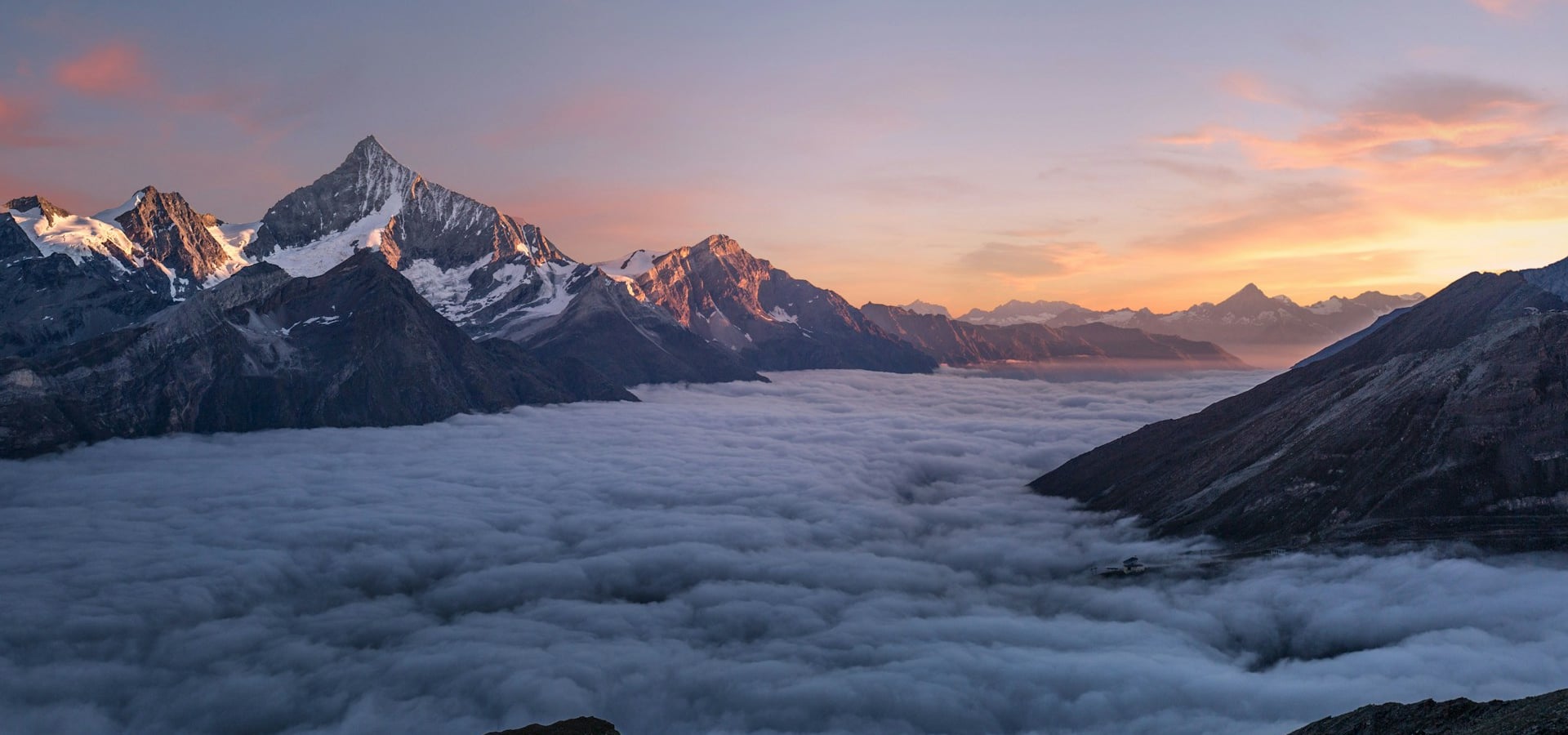 Mountain sunrise over green valleys